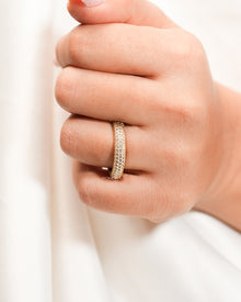 Wide lab grown diamond pavé band worn on hand in yellow gold