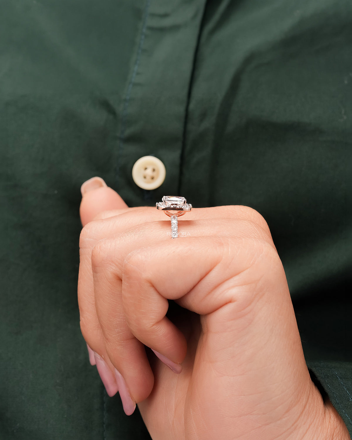 Cushion moissanite halo ring worn with white silk