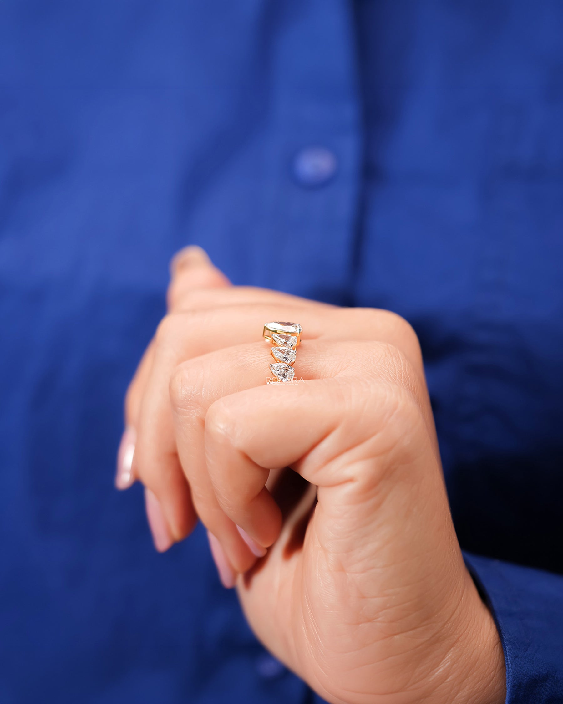 Pear lab grown diamond five-stone band worn with white silk
