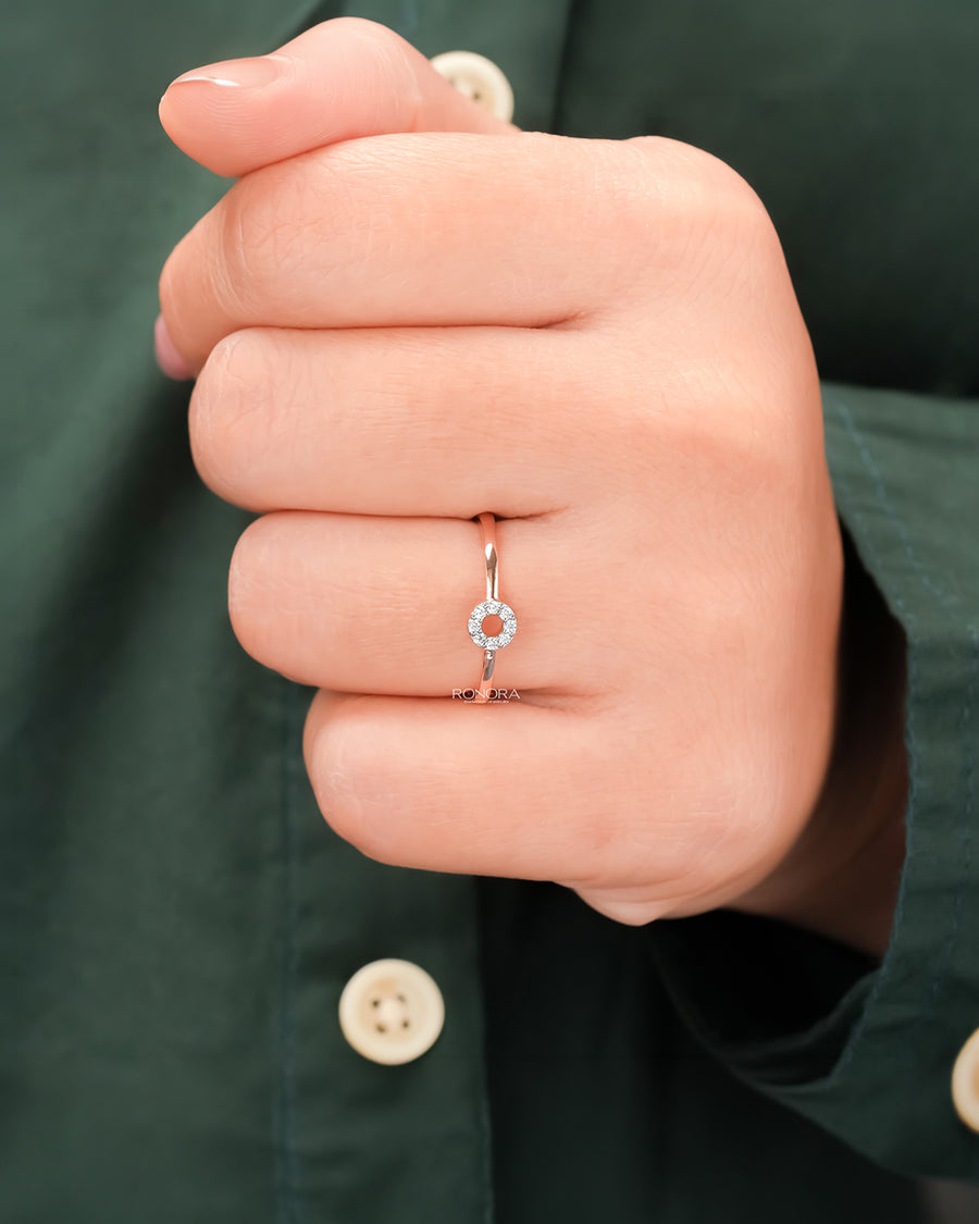 Round lab grown diamond halo ring worn on hand in rose gold
