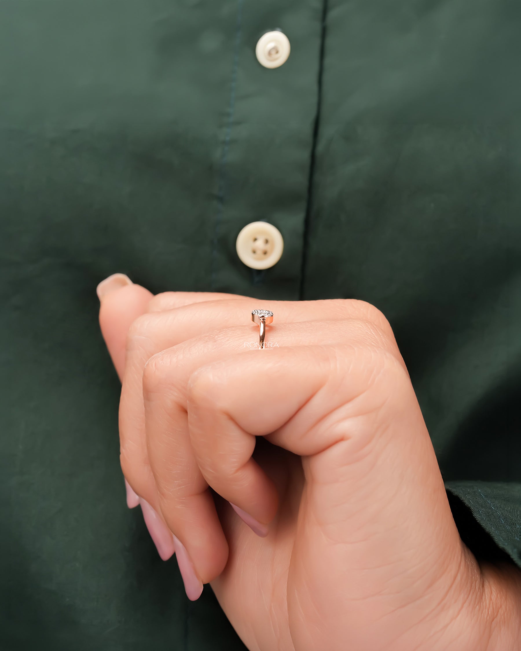 Round lab grown diamond halo ring worn with dark green styling