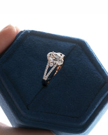 Angled view of oval lab grown diamond halo ring with halo split-shank setting