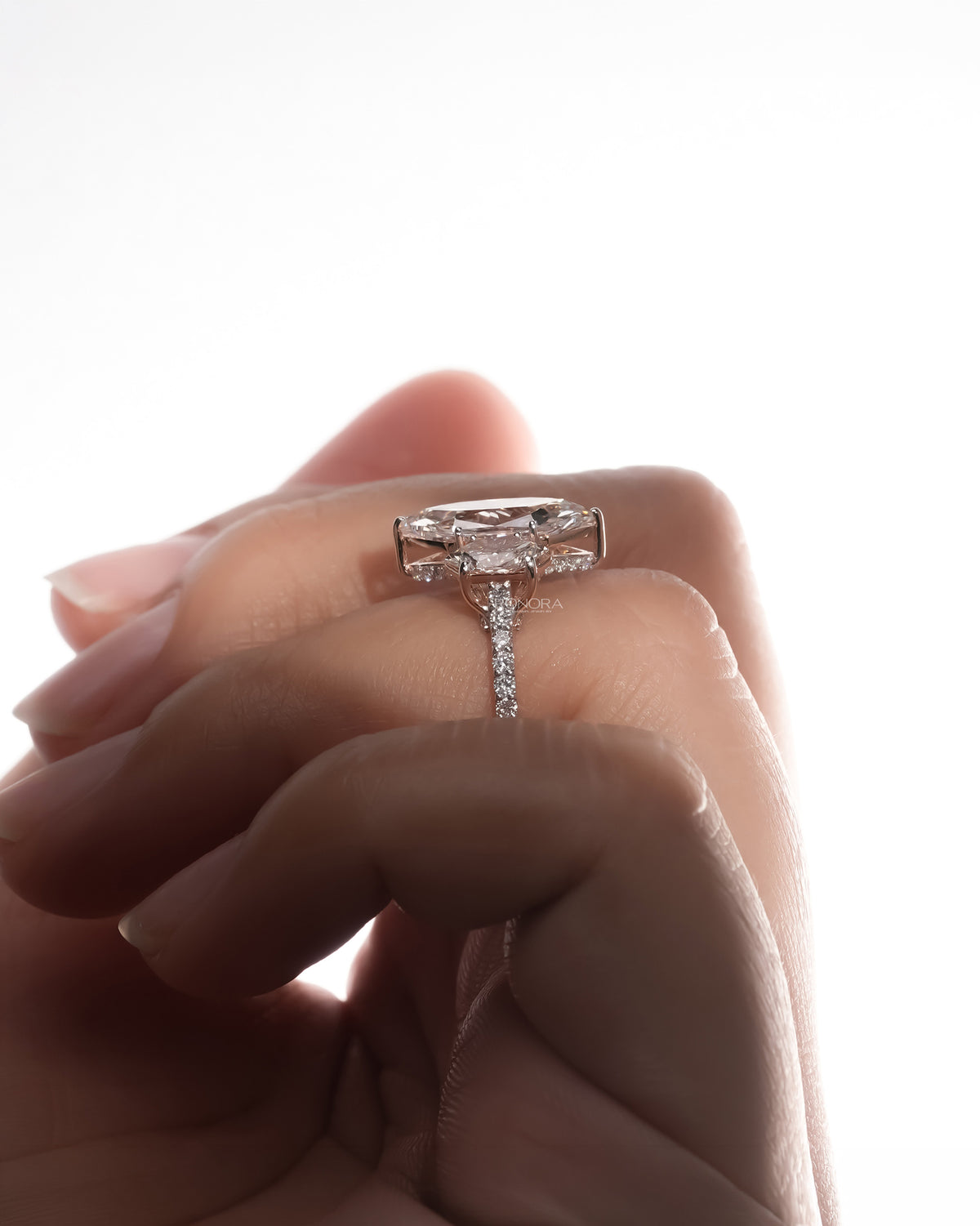 Side profile of marquise lab grown diamond three-stone ring showing ring setting