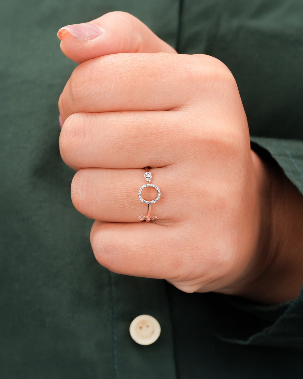 Round lab grown diamond open halo ring worn on hand in rose gold