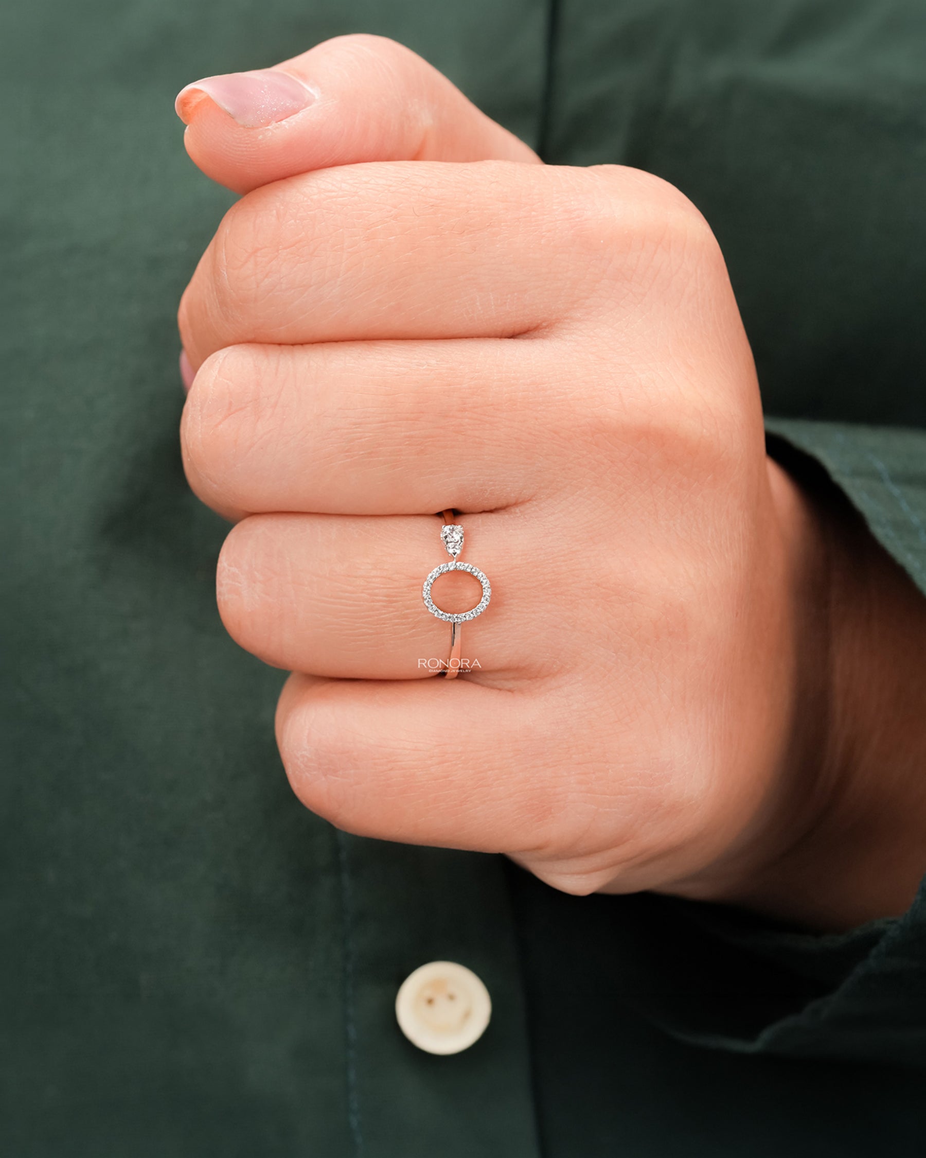 Round lab grown diamond open halo ring worn on hand in rose gold