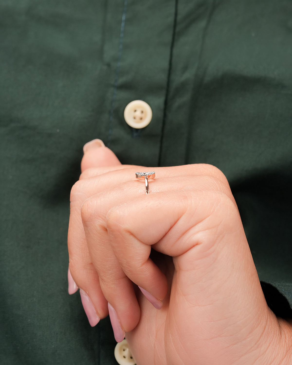 Round lab grown diamond open halo ring worn with dark green styling