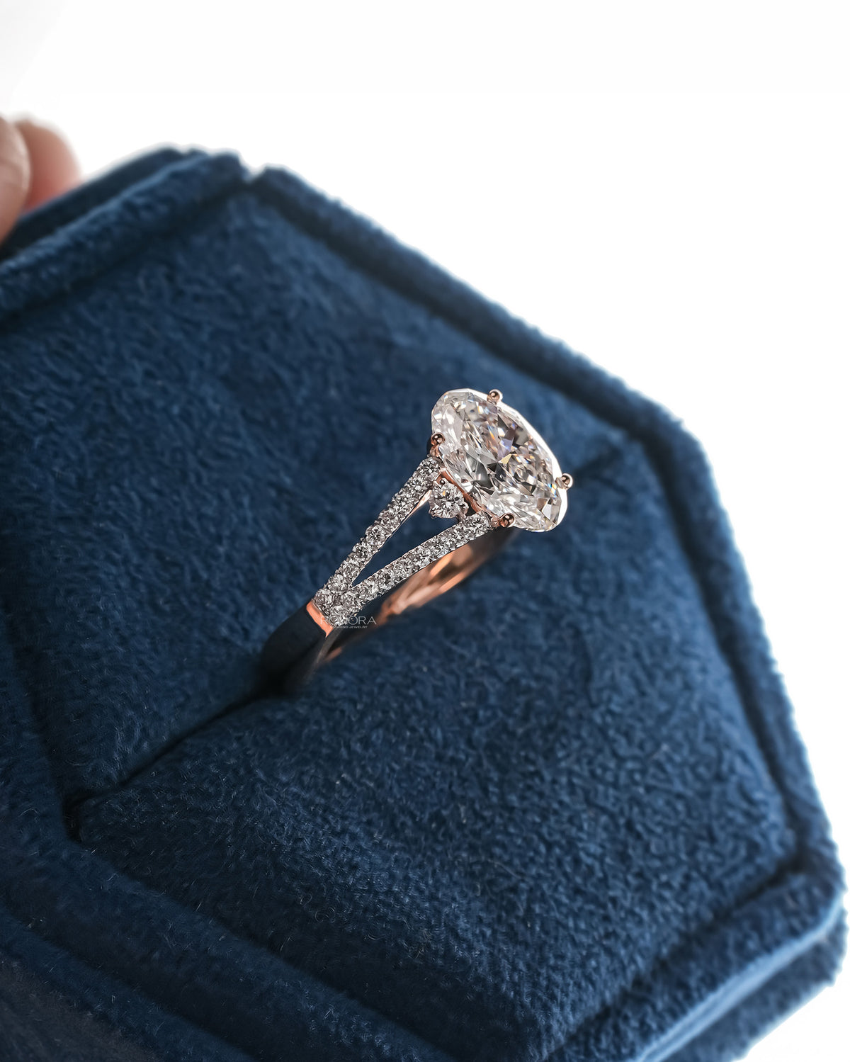 Side profile of oval lab grown diamond halo ring showing ring setting