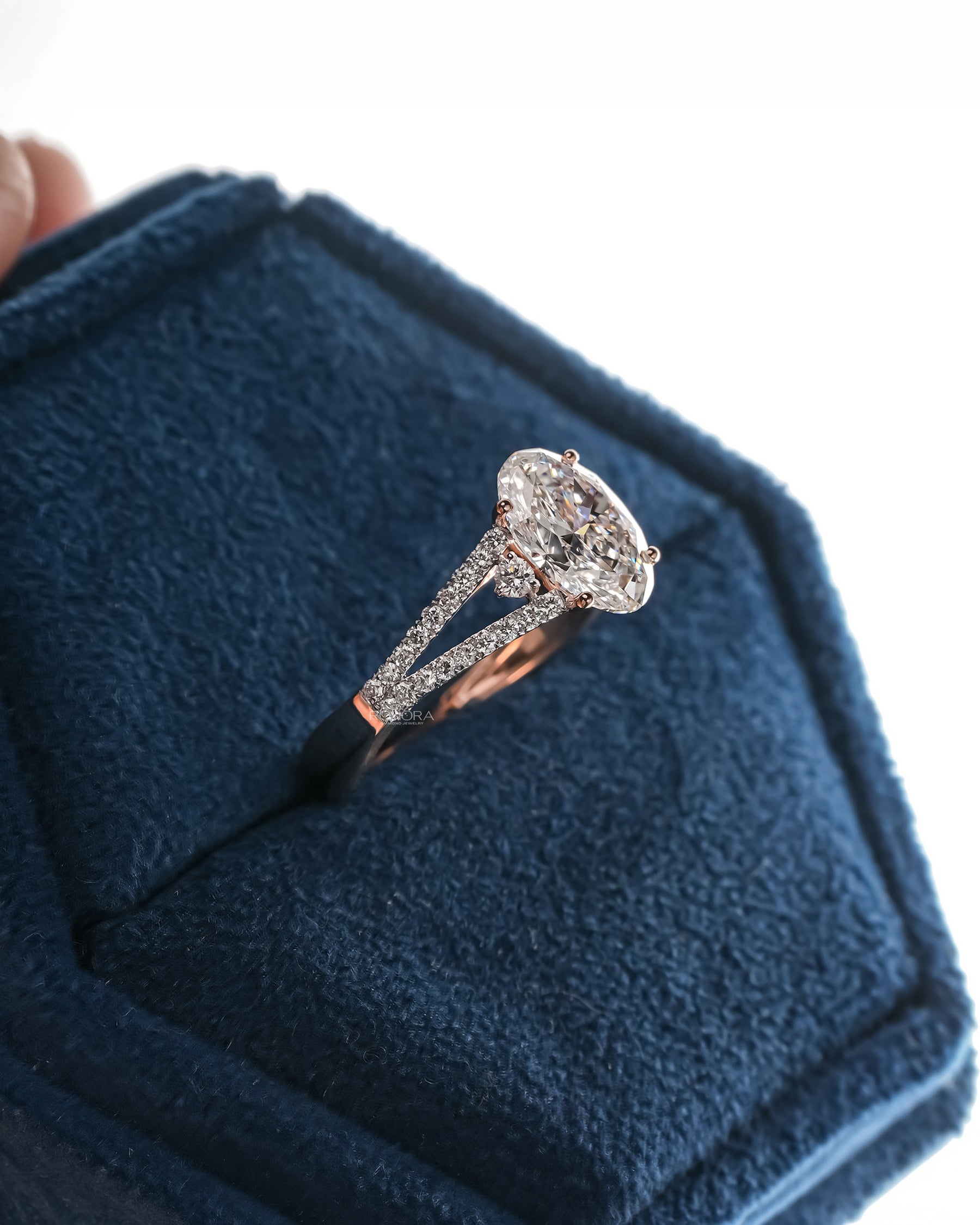 Side profile of oval lab grown diamond halo ring showing ring setting