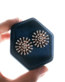 Starburst cluster lab grown diamond earrings in rose gold in a navy velvet hex box held in hand