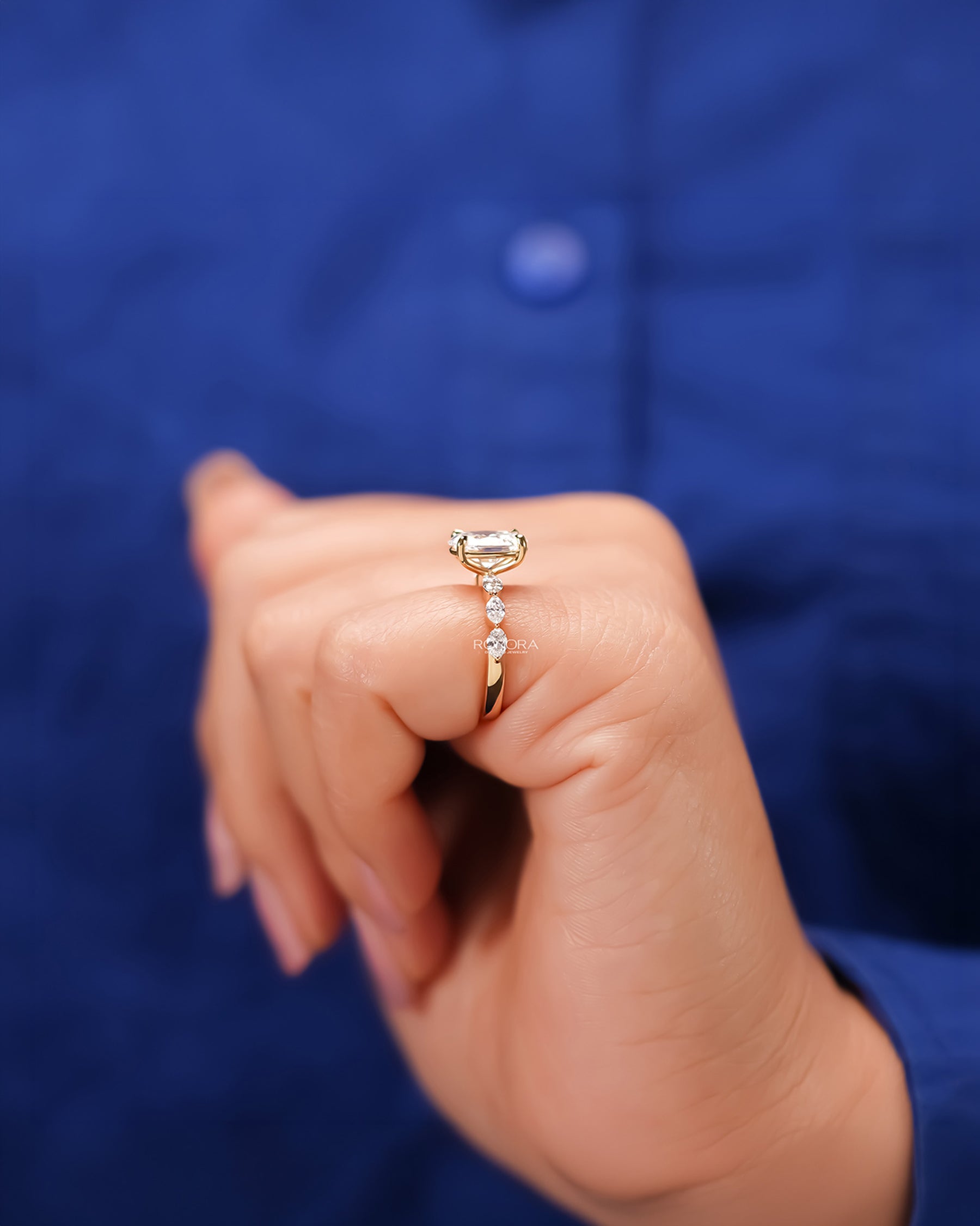 Oval lab grown diamond side-stone ring worn with white silk