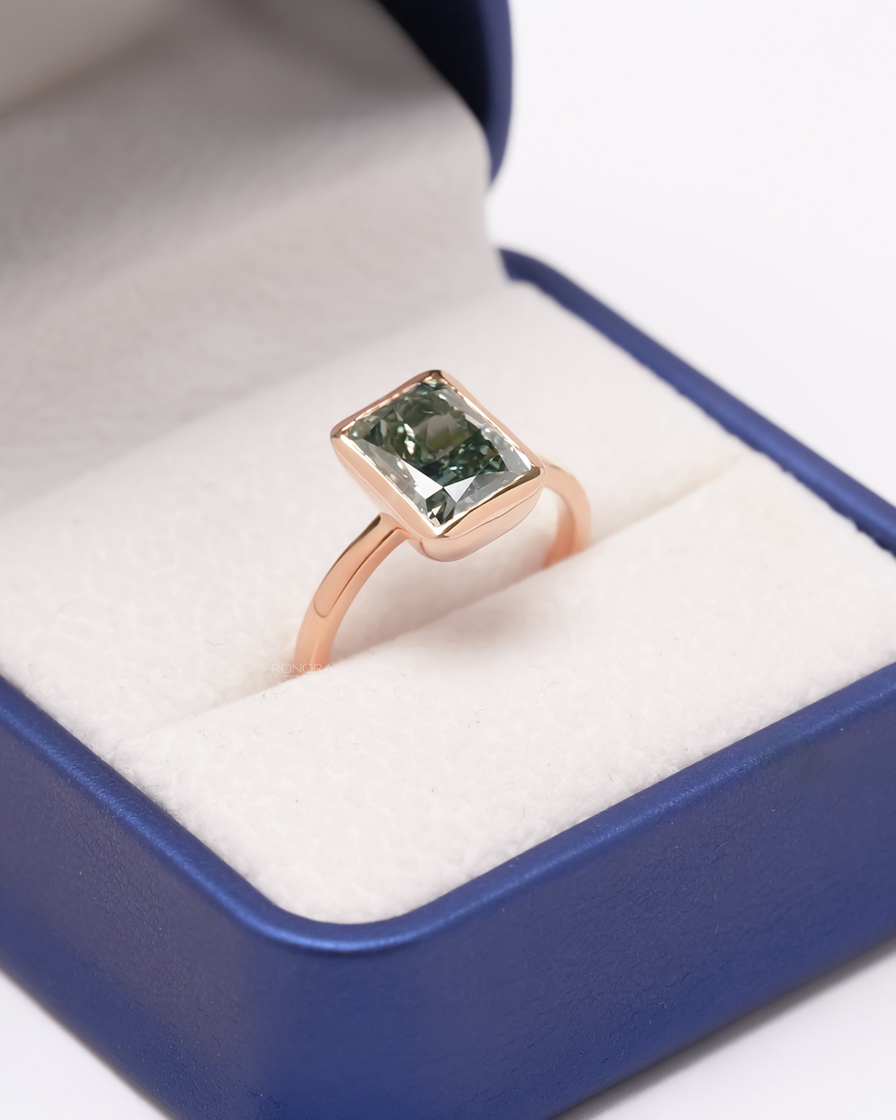 Green radiant lab grown diamond ring in Ronora box with bezel-style setting