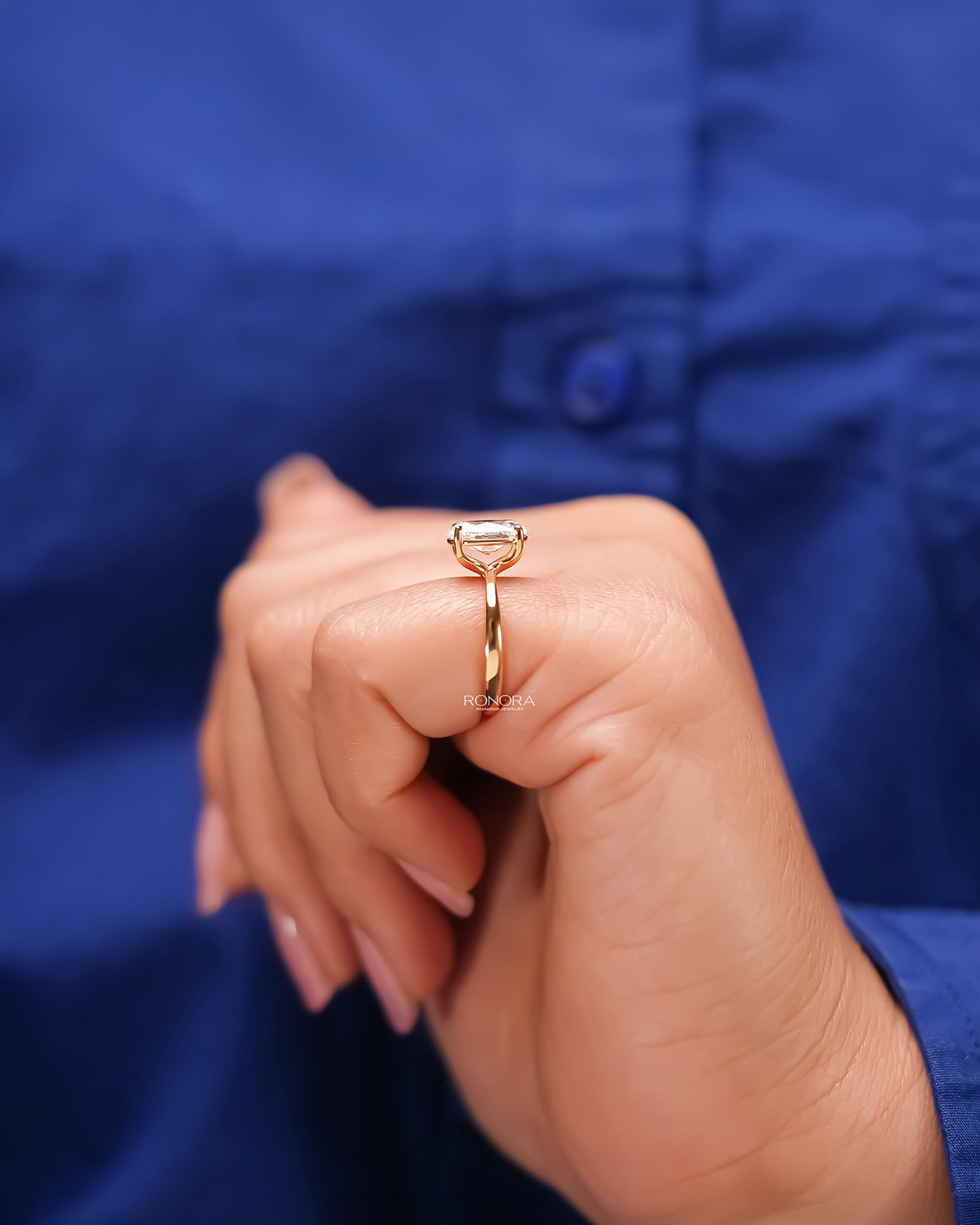Oval lab grown diamond solitaire ring worn with white silk