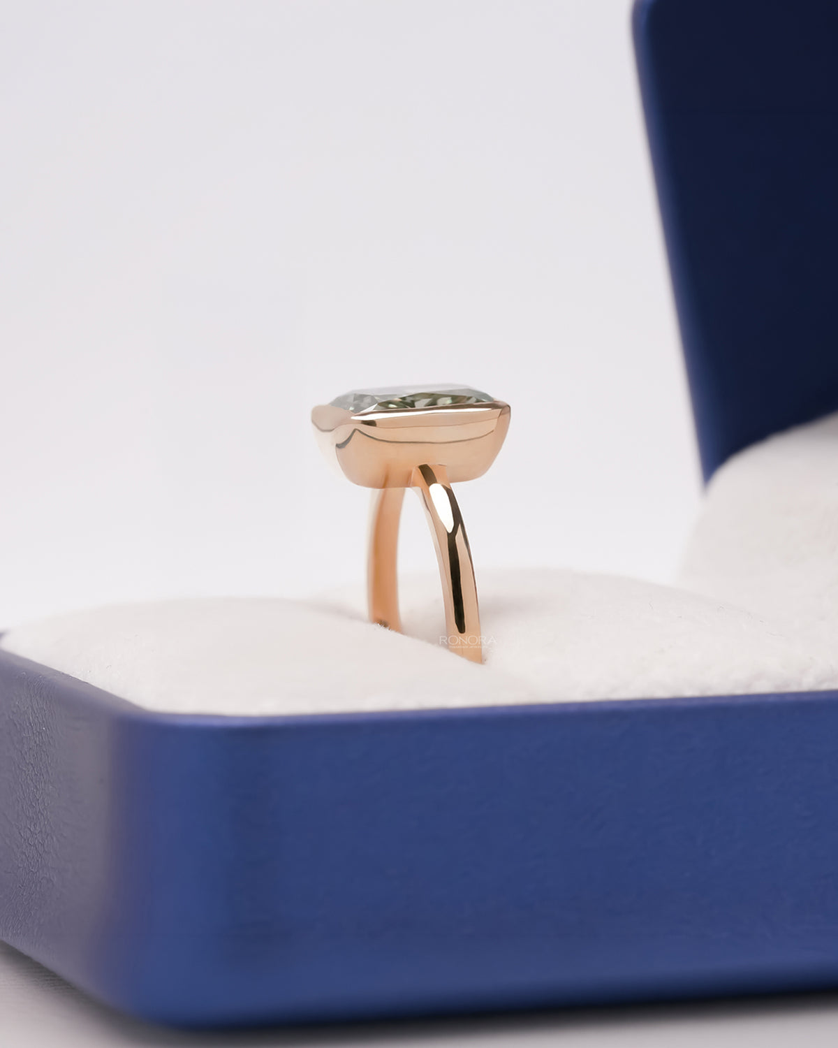 Side profile of green radiant lab grown diamond solitaire ring showing raised setting