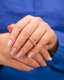 Round lab grown diamond five-stone band worn on hand in yellow gold