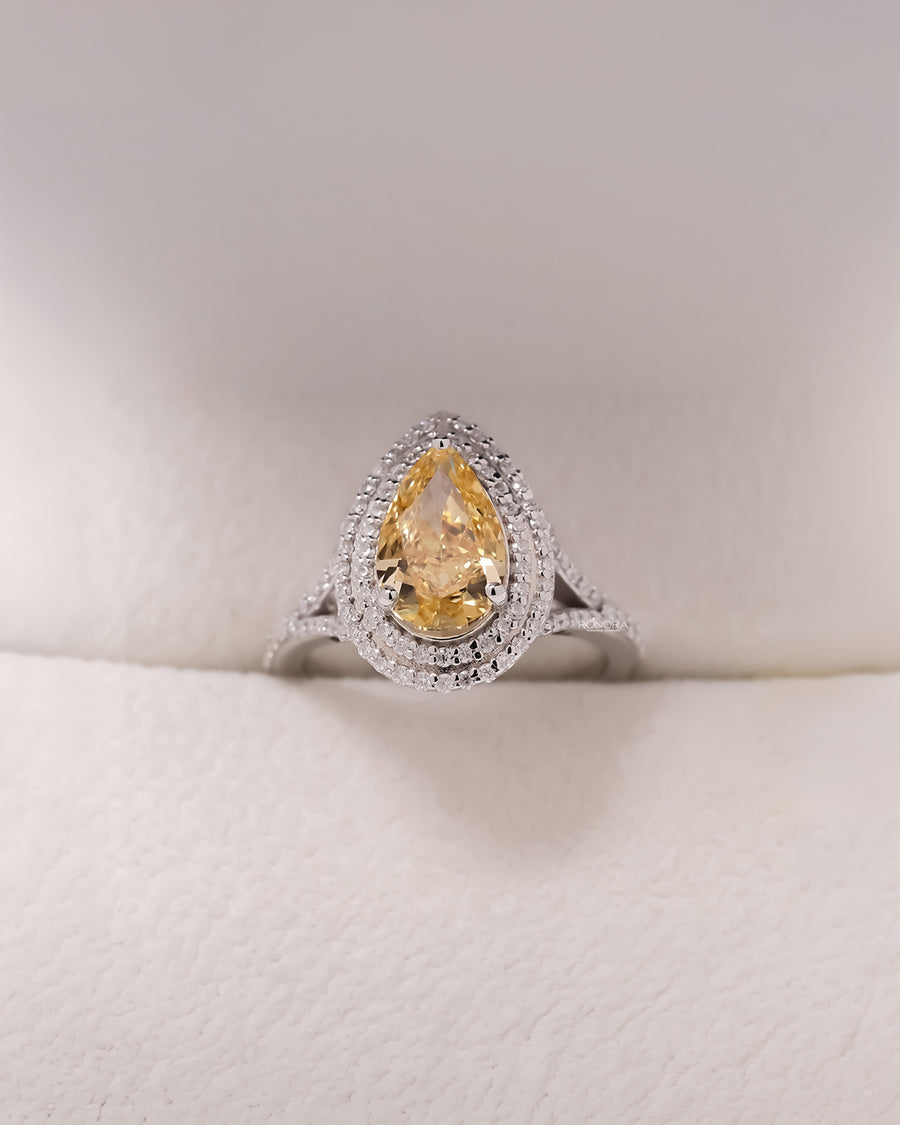 Solara yellow pear lab grown diamond halo ring in white metal inside Ronora box