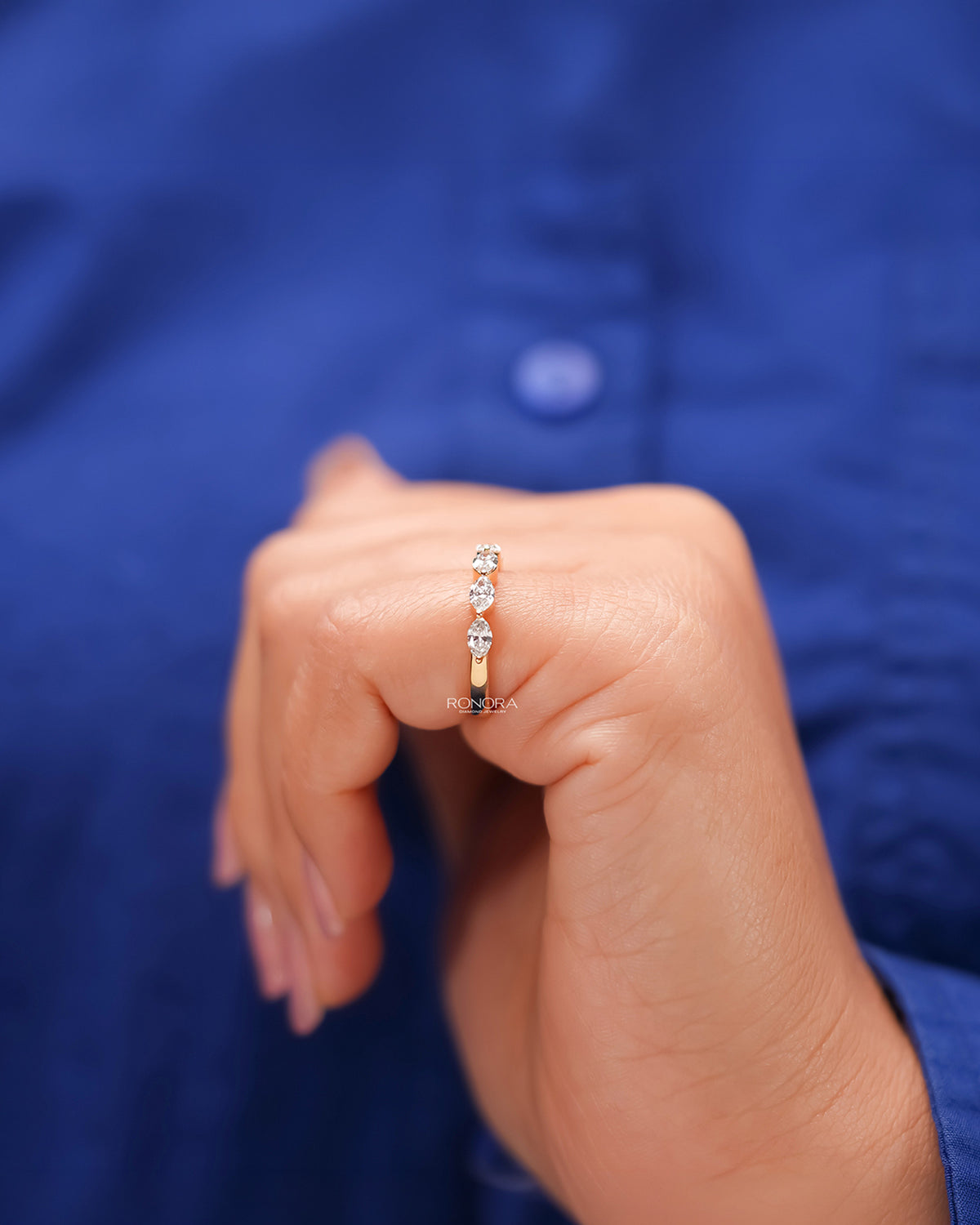 Round lab grown diamond five-stone band worn with white silk