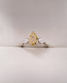 Aureline yellow pear lab grown diamond three-stone ring in white metal inside Ronora box
