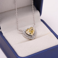 Yellow heart cut lab grown diamond necklace with a double diamond halo in white gold, resting in a blue ring box