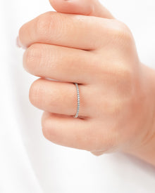 Slim lab grown diamond pavé eternity band worn on hand in rose gold