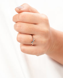 Two-stone lab grown diamond wave ring worn on hand in rose gold