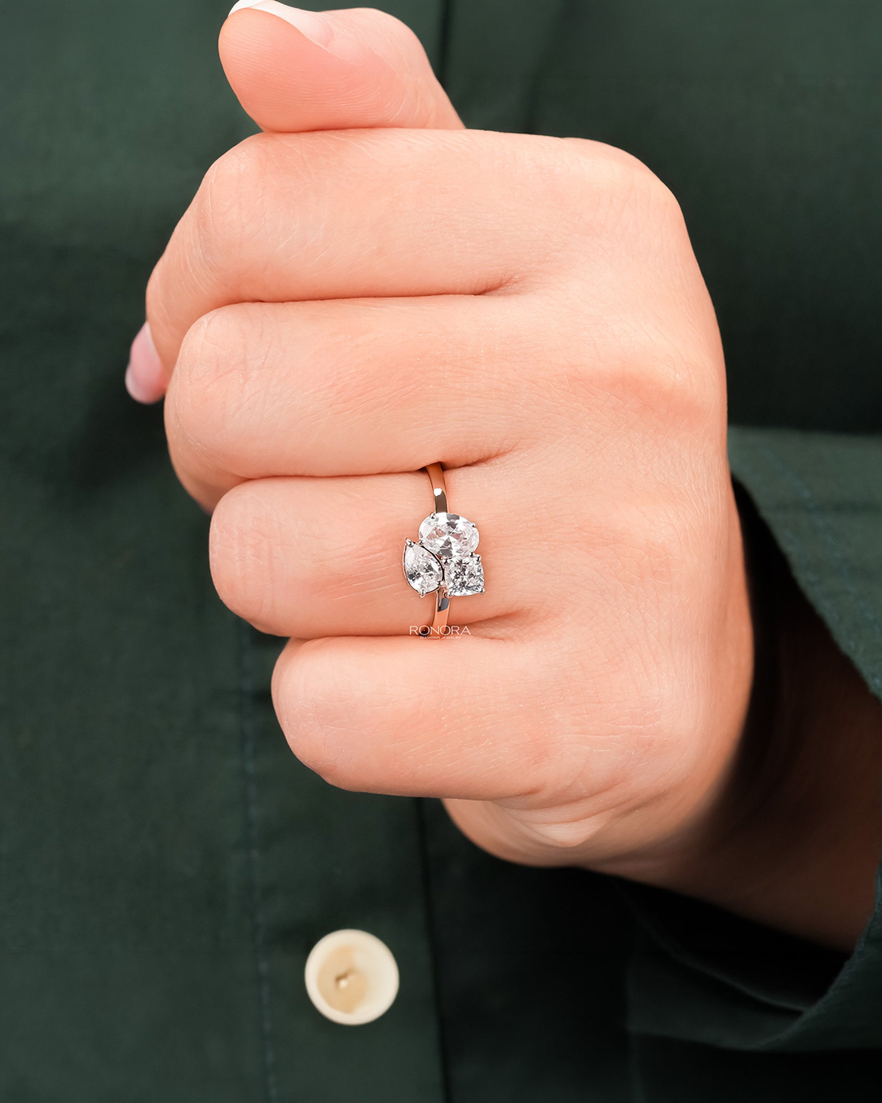 oval lab grown diamond cluster ring worn on hand in rose gold