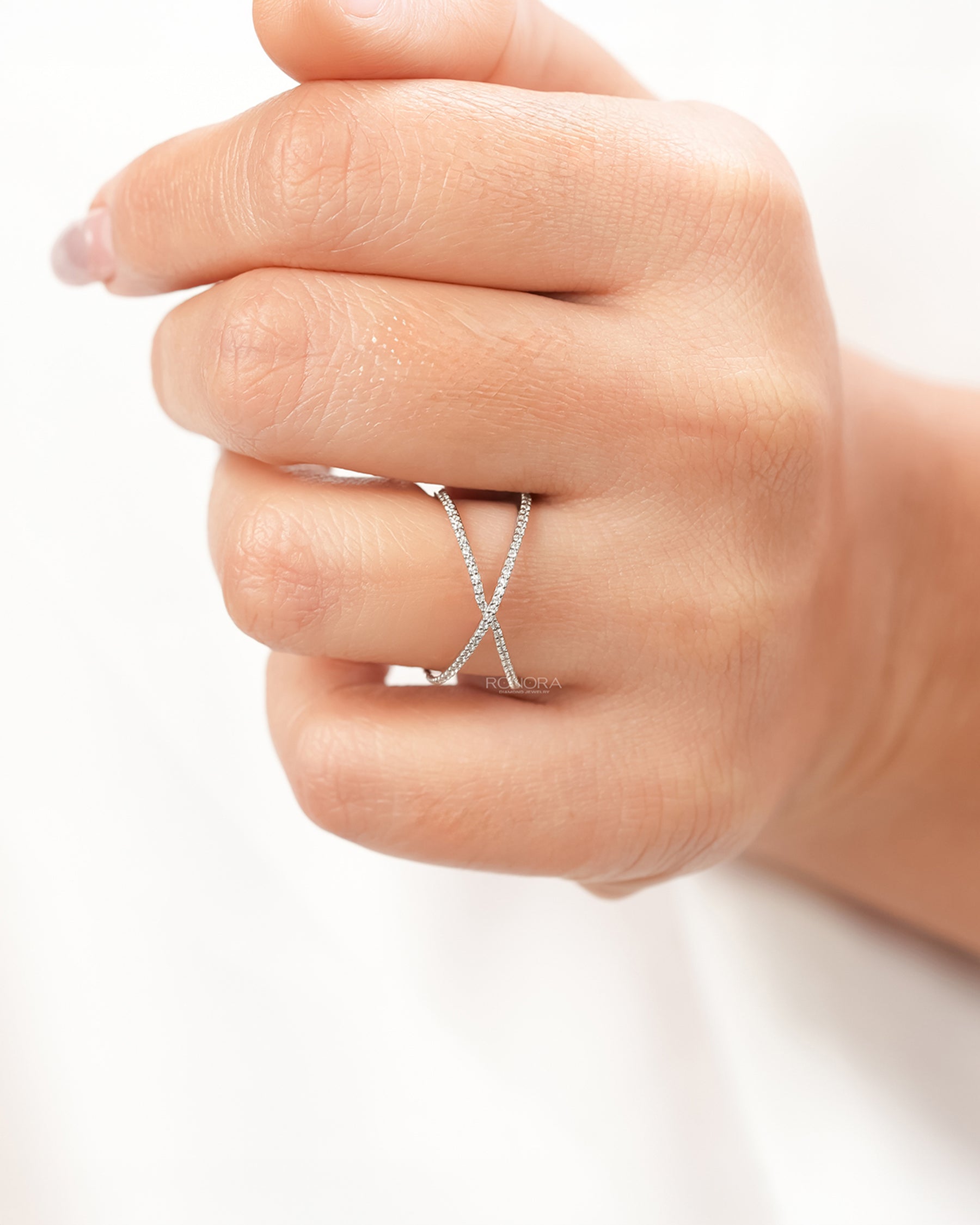 White lab grown diamond crossover ring worn on hand