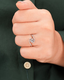 Round lab grown diamond twisted pavé ring worn on hand in rose gold