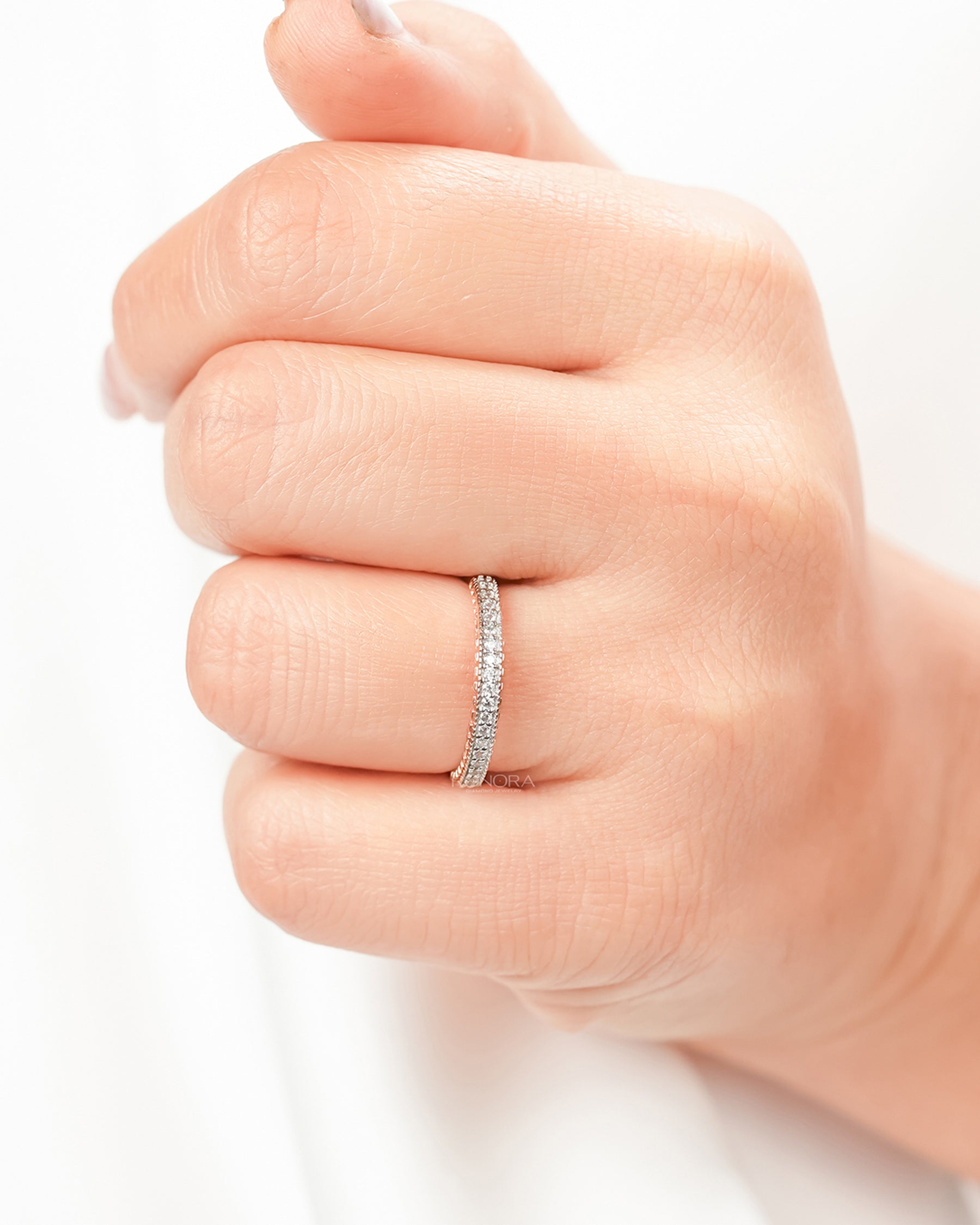 Double-row lab grown diamond pavé band worn on hand in rose gold