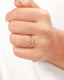 Minimal round lab grown diamond solitaire ring worn on hand in rose gold