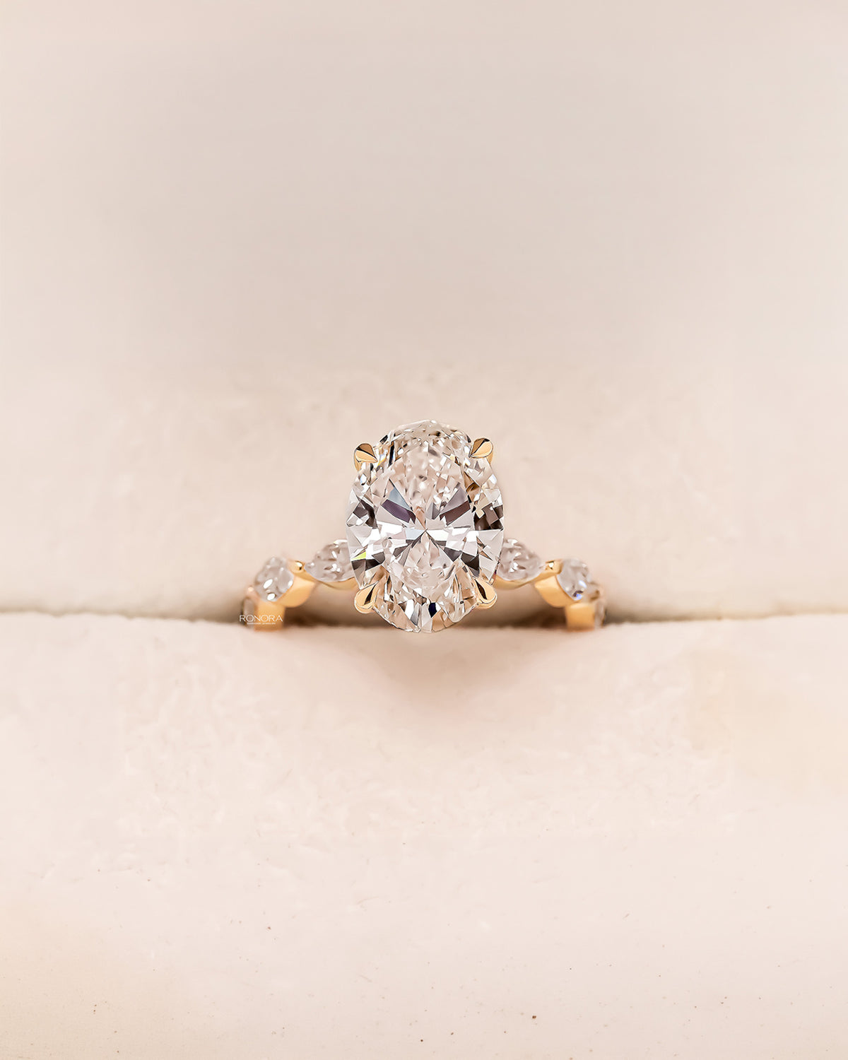 Alessia oval marquise lab grown diamond three-stone ring in yellow gold inside Ronora box