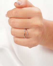 Open lab grown diamond bypass ring worn on hand in rose gold