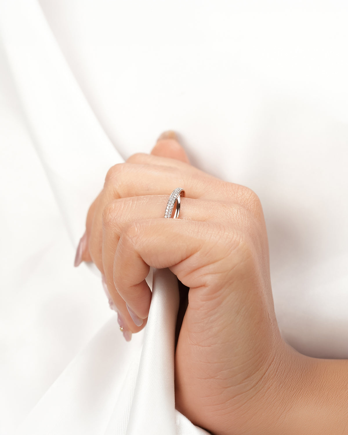 Curved double-row lab grown diamond pavé band worn with white silk
