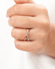 Twisted lab grown diamond pavé ring worn on hand in rose gold