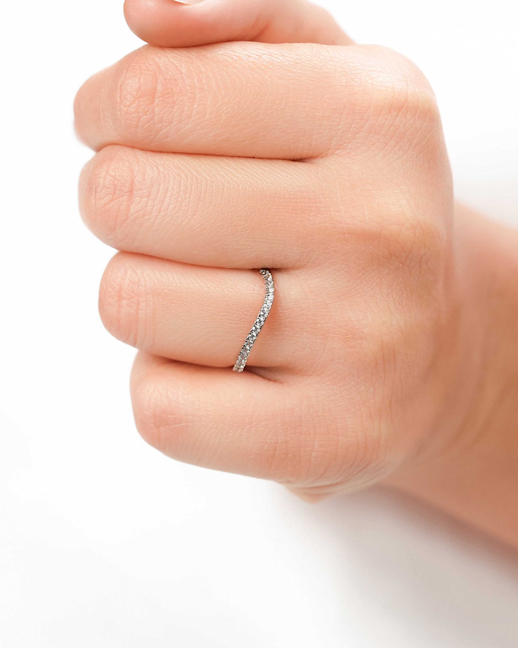 Curved lab grown diamond pavé band worn on hand in rose gold