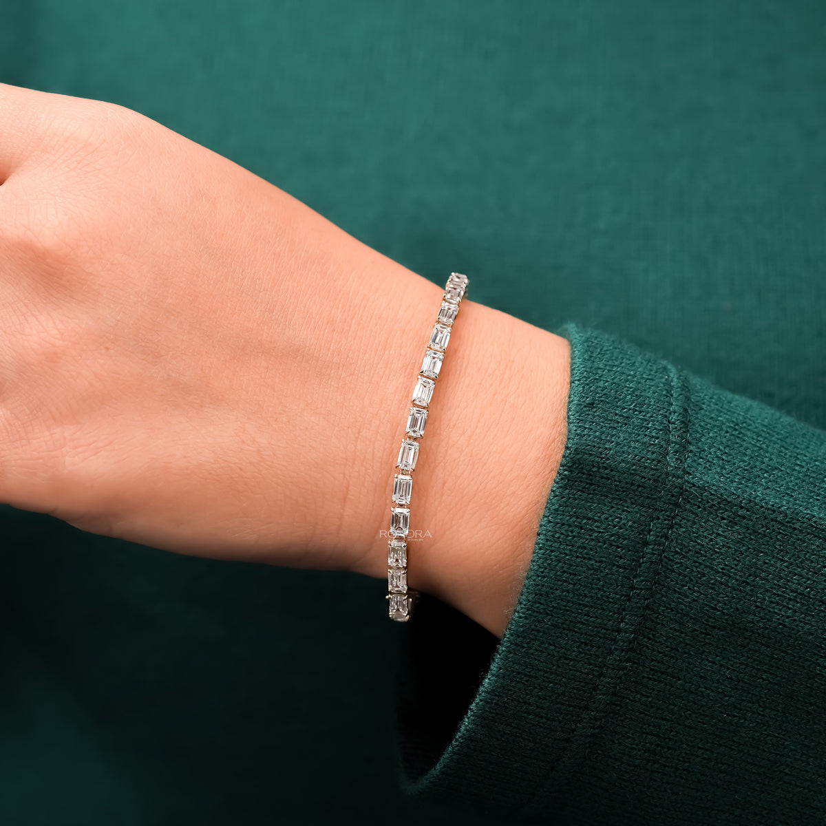 Emerald lab grown diamond tennis bracelet worn with green sleeve
