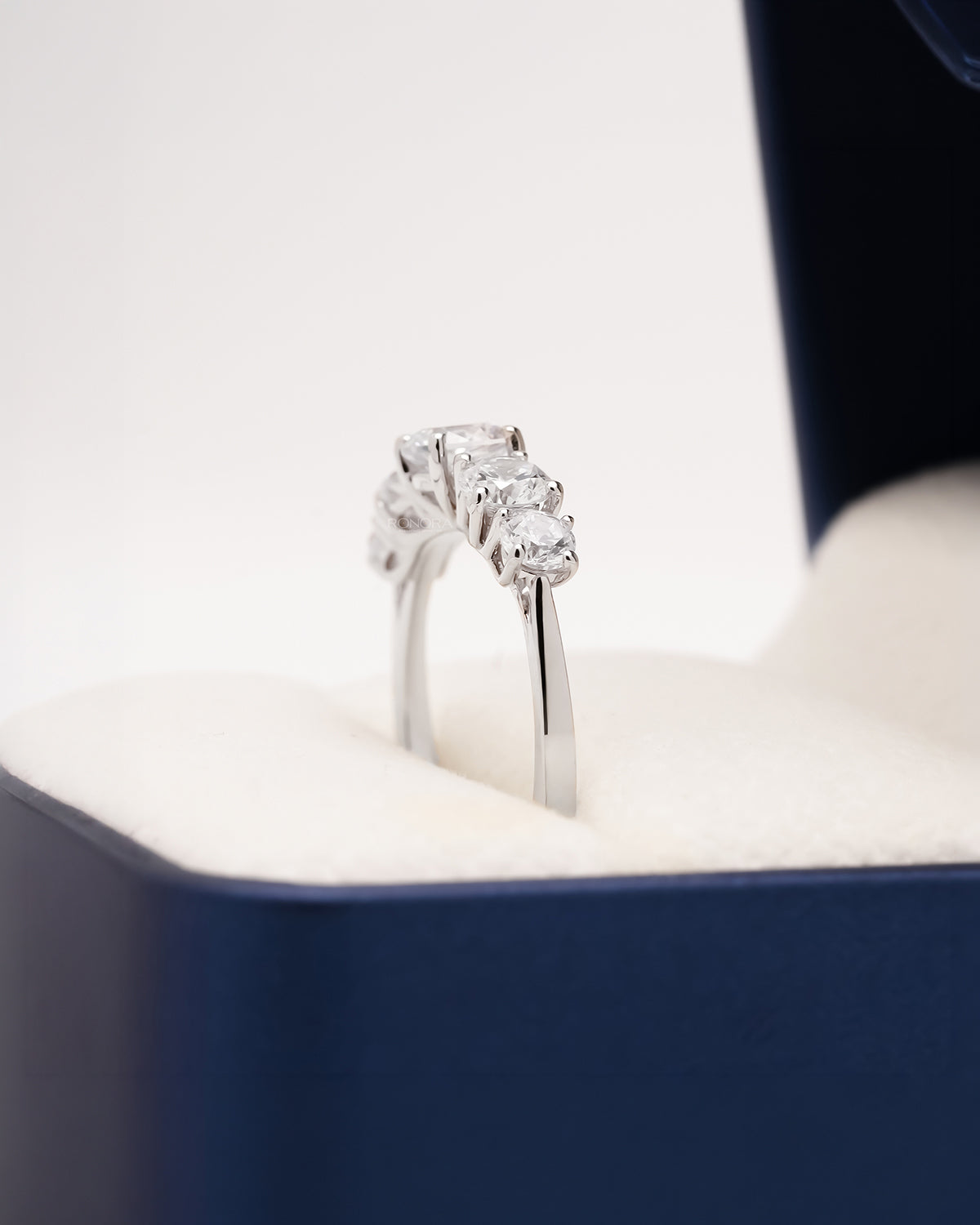 Side profile of five-stone lab grown diamond ring showing prong setting