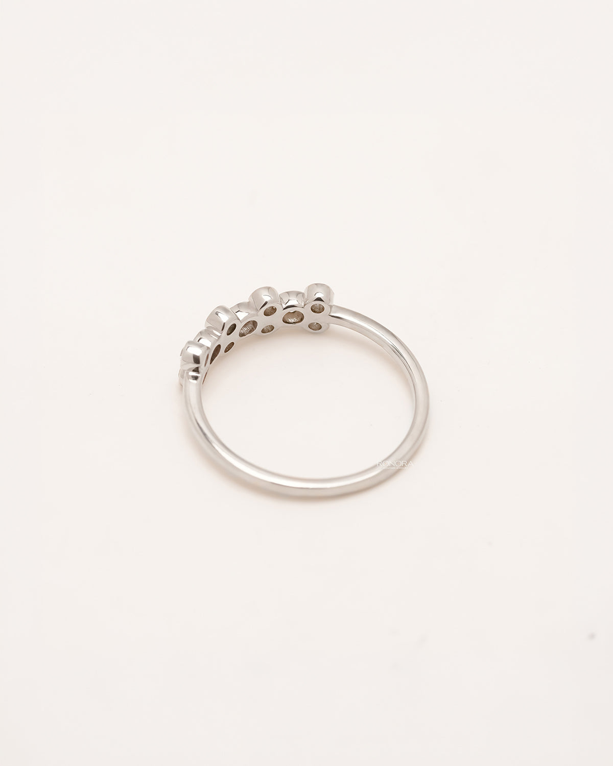 Back view of round lab grown diamond five-stone band showing slim shank