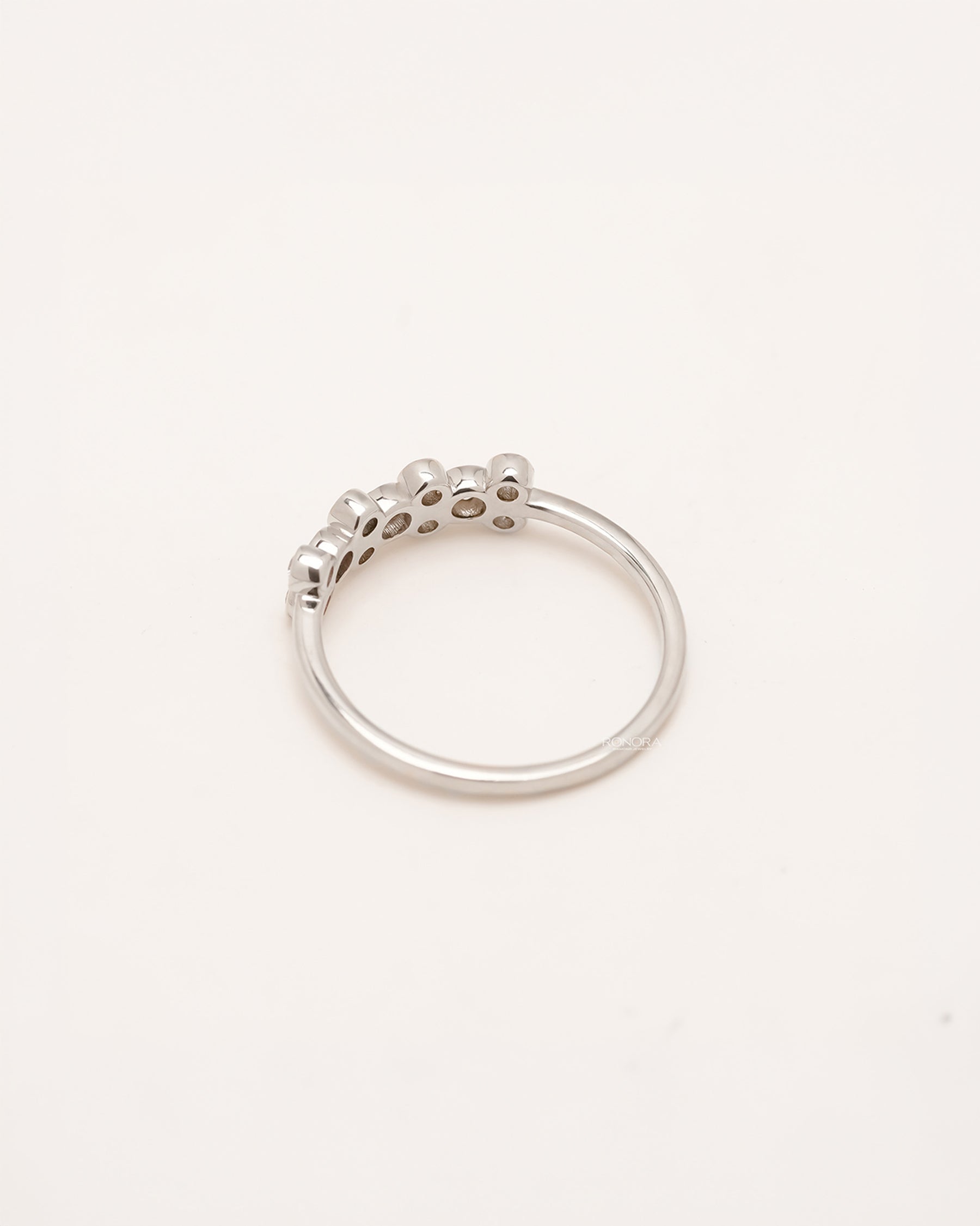Back view of round lab grown diamond five-stone band showing slim shank