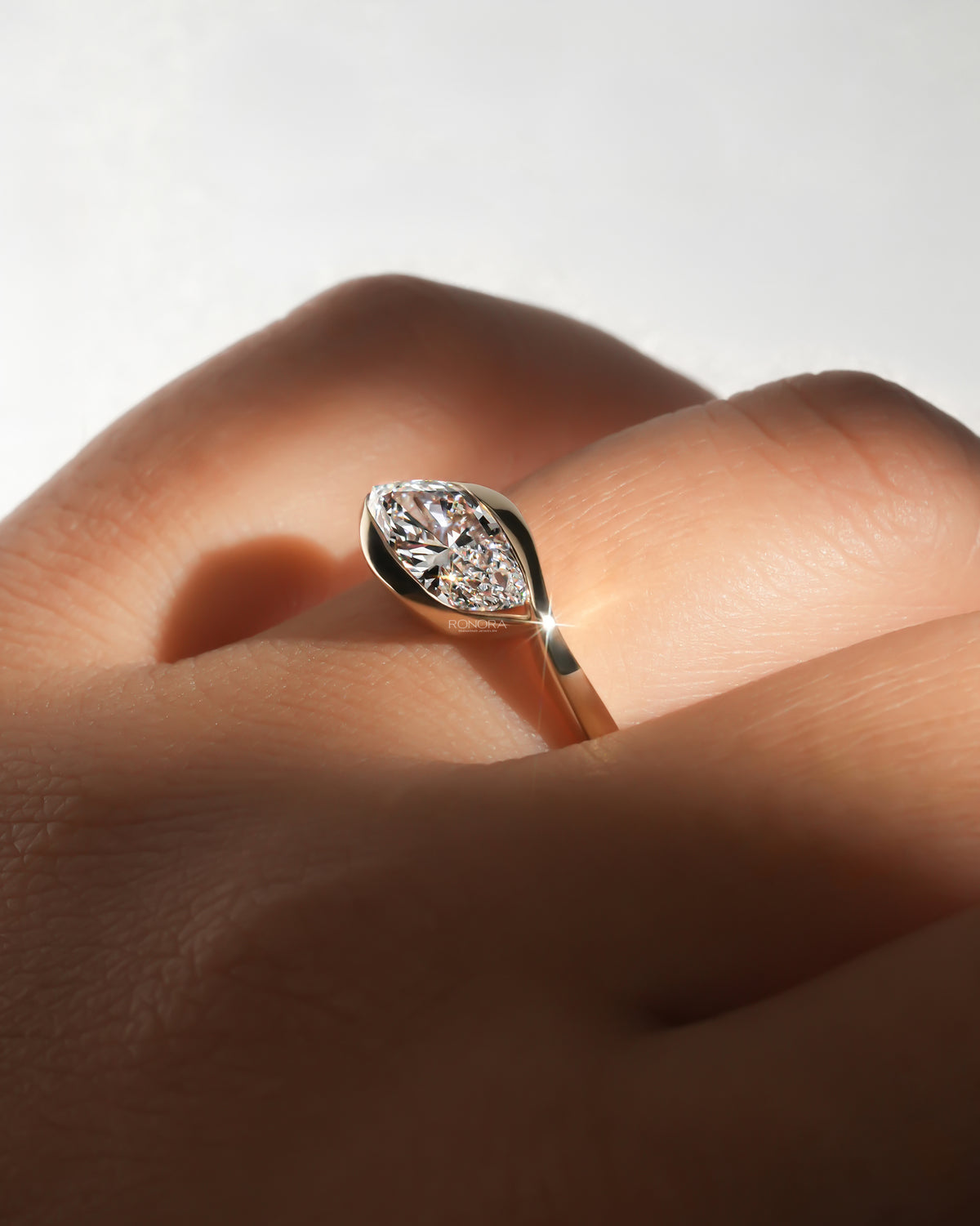 Close-up of the marquise bezel lab grown diamond ring on the finger