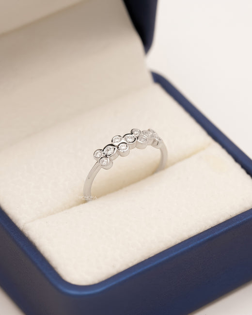 Adelina round lab grown diamond five-stone band in white metal inside Ronora box