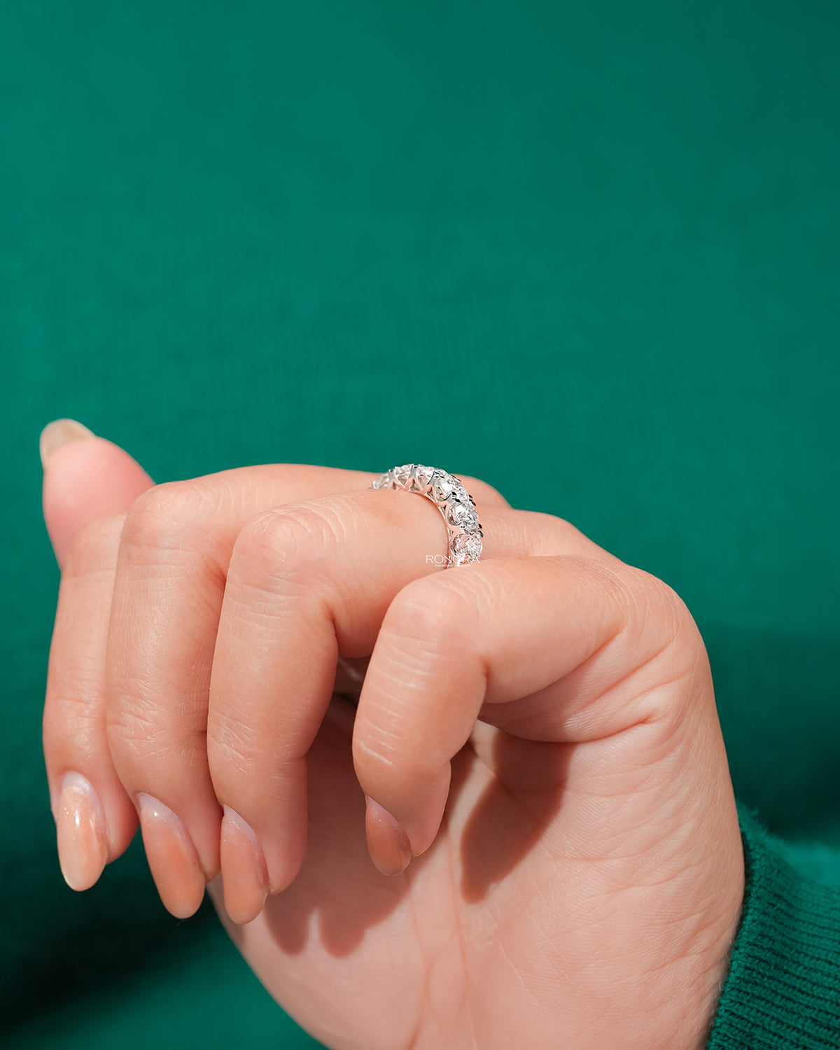 round lab grown diamond eternity band worn with luxury styling in white gold