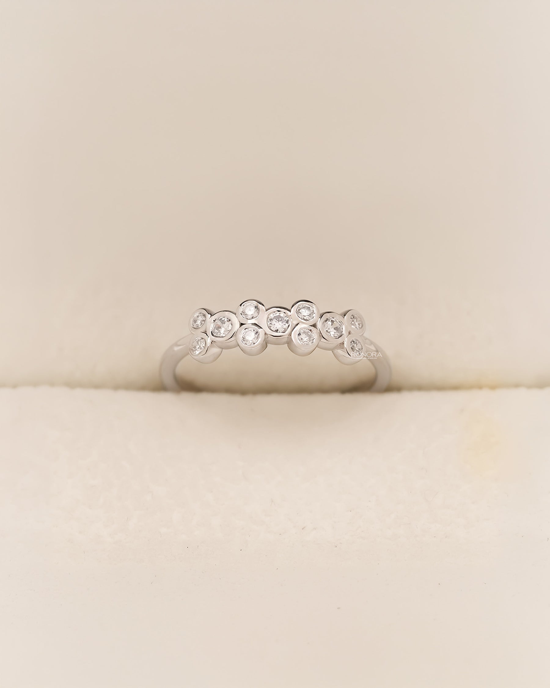 White metal five-stone band with round lab grown diamonds in Ronora box