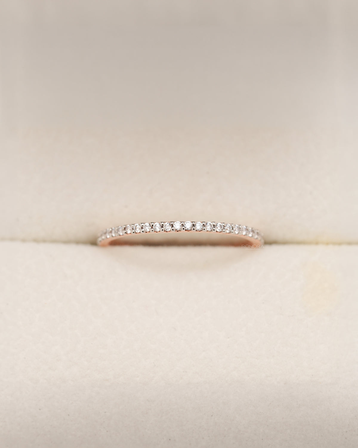 Rose gold pavé eternity band with round lab grown diamonds in Ronora box