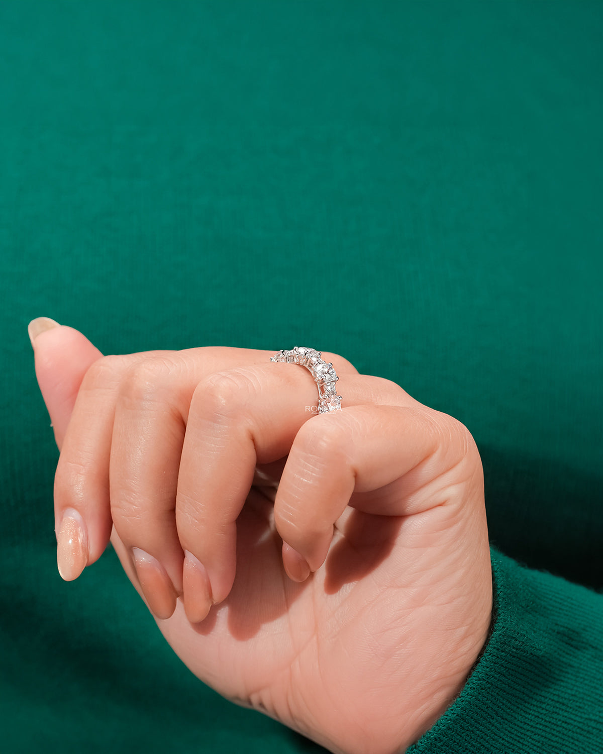 Side profile of round lab grown diamond eternity band showing ring setting
