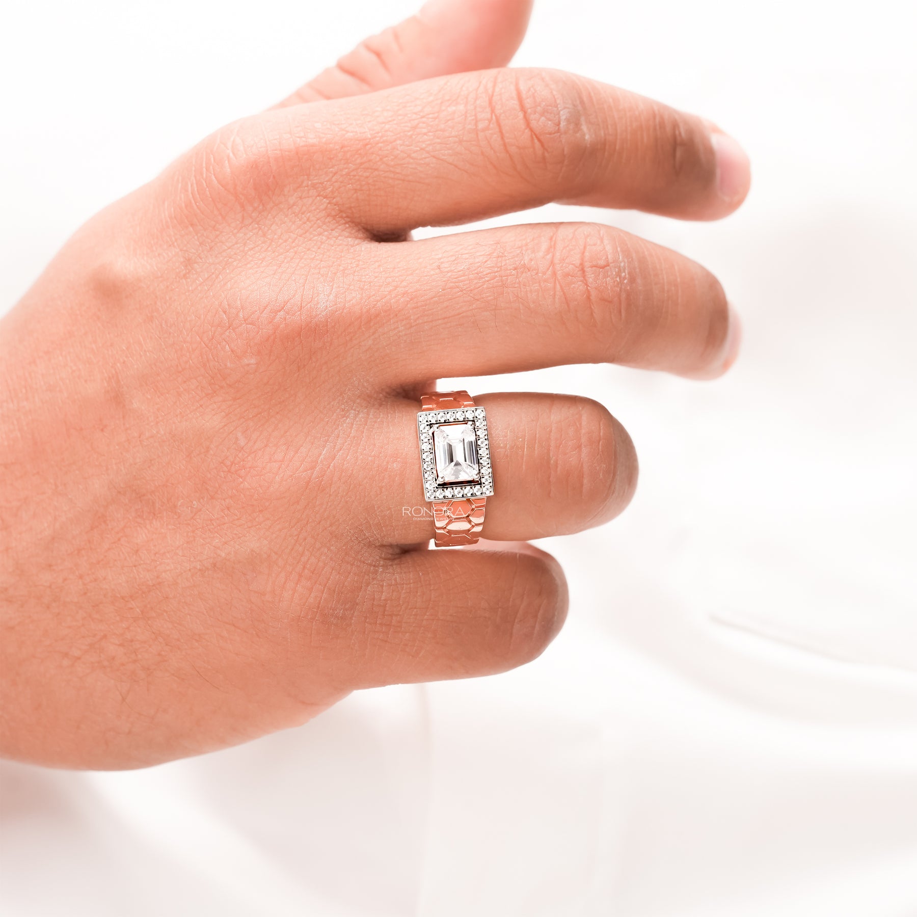 emerald moissanite halo men's ring worn on hand in rose gold