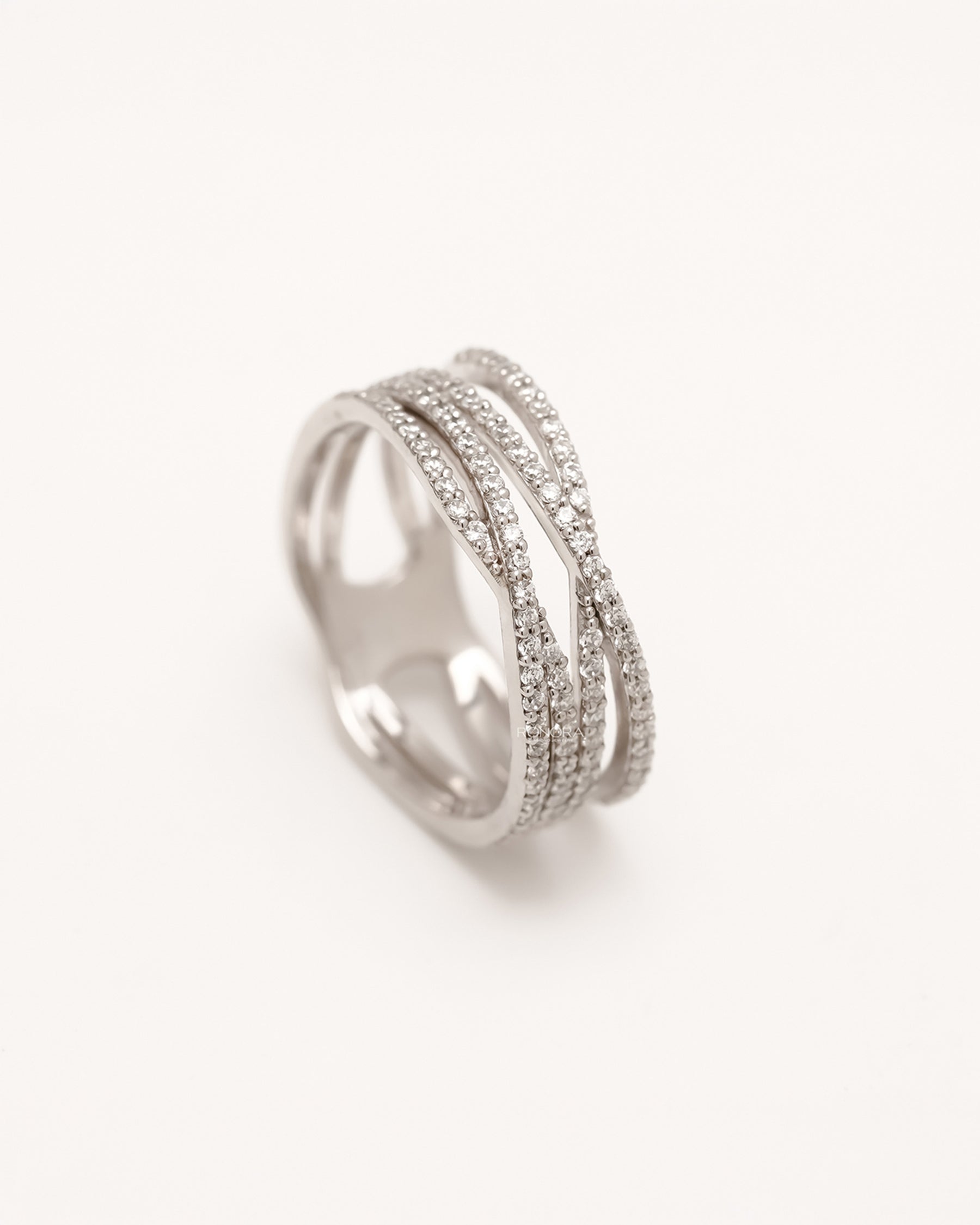 Angled view of four-band crossover ring with round pavé lab grown diamonds