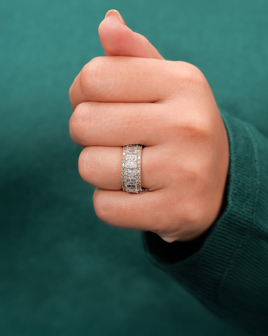radiant lab grown diamond eternity band worn on hand in yellow gold