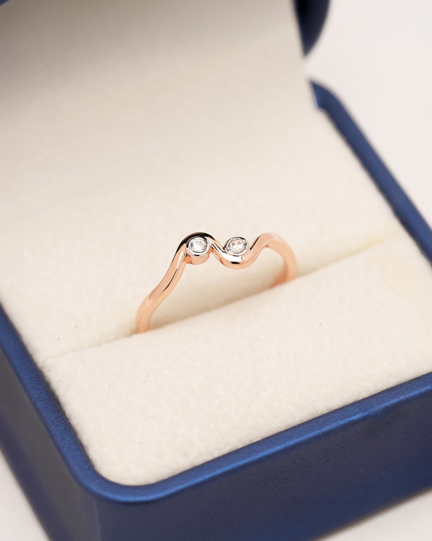 Liora two-stone lab grown diamond wave ring in rose gold with round bezel-set diamonds