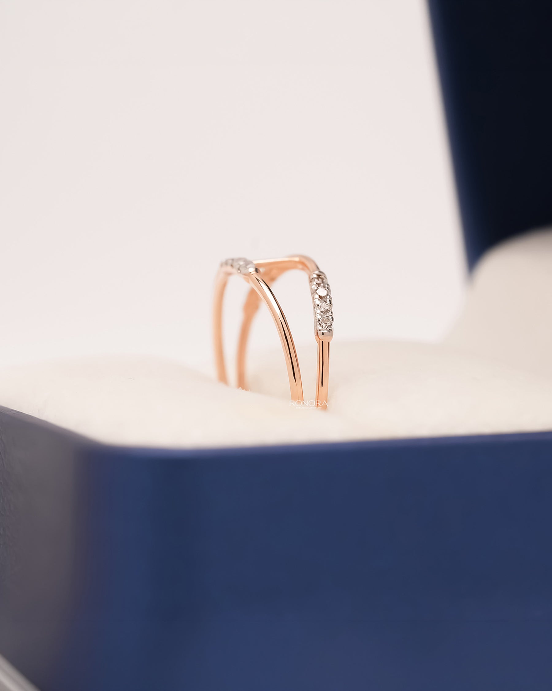Side profile of open bypass lab grown diamond ring showing pavé curve