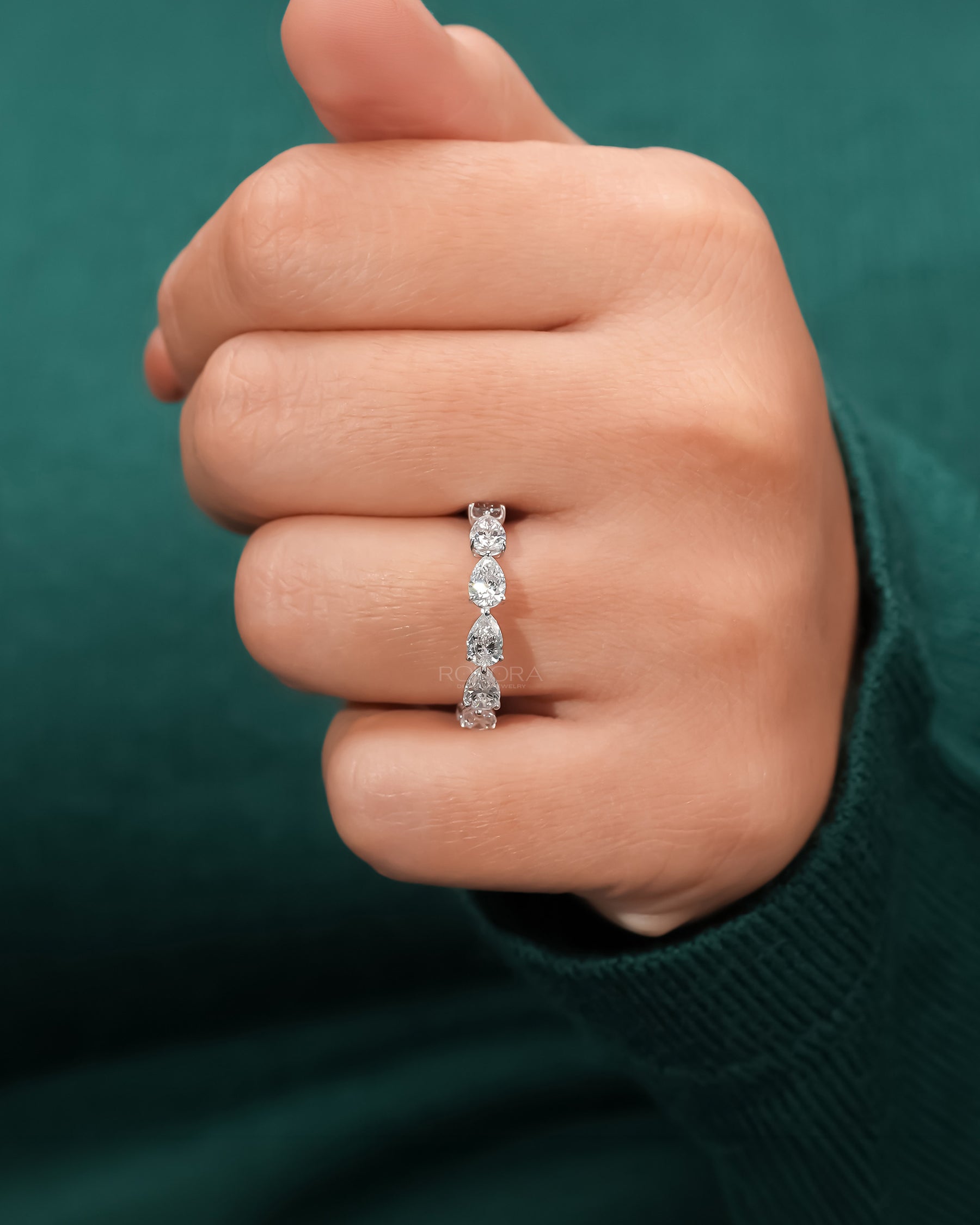 pear lab grown diamond eternity band worn on hand in white gold